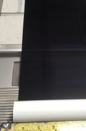 Mylar sun shade material carefully measured to customer-provided dimensions before fabrication